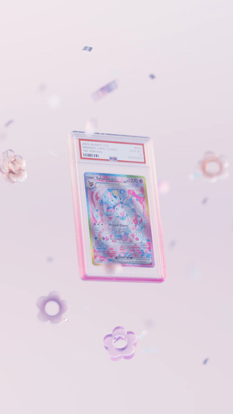 Bumpii Lychee slab protector floats through a soft pink scene, highlighting its clear pink frame around a PSA graded card.